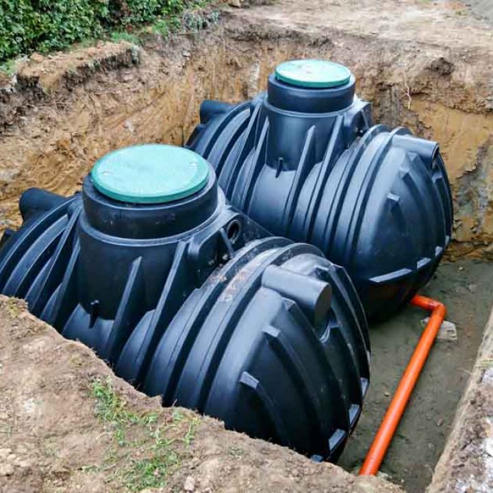 Two plastic underground storage tanks placed below ground for harvesting a rainwater.